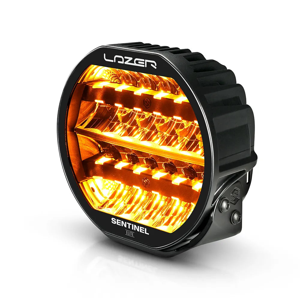 Musta Lazer Sentinel Elite 9-tuumainen lisävalo, jossa on pyöreä muotoilu, oranssit LED-parkkivalot, heijastimet useassa rivissä ja jäähdytysrivat taustalla. Valo on valkoista taustaa vasten ja kuvattu yläviistosta.
